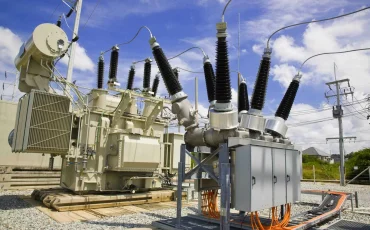 Electrical transformers and insulators in a power substation.