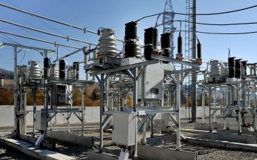 High-voltage electrical substation with transformers and power lines.