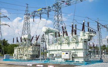 High-voltage electrical substation with transformers and power lines.